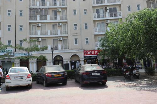 a group of cars parked in front of a building at Omaxe Eternity-Near Prem Mandir in Vrindāvan