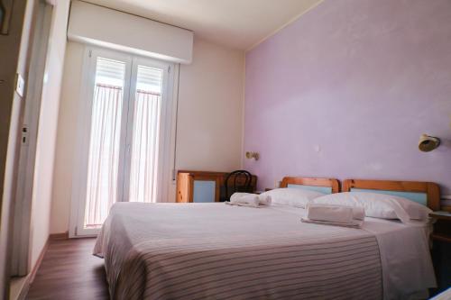 Ένα ή περισσότερα κρεβάτια σε δωμάτιο στο Hotel Jolie