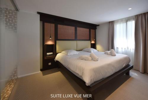 a bedroom with a bed with two towels on it at HOTEL SAINT ROCH in Ogliastro