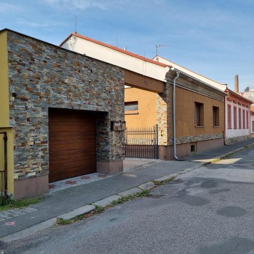 an empty street with a brick building with a garage at Apartmány 235 - 1 in Jaroměř