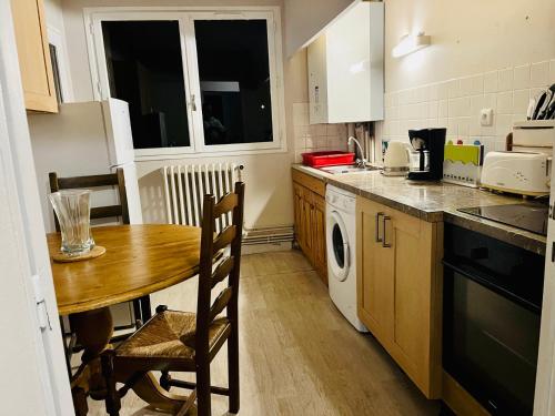 a small kitchen with a wooden table and a sink at Mountain view 2-bedroom Pyrenees apartment in Saint-Béat