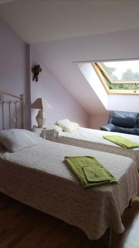 a bedroom with two beds and a window at La Tebaida in Ponferrada