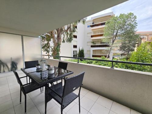un balcon avec une table et des chaises sur un balcon dans l'établissement 45m2 Luxueux 2P hypercentre terrasse Parking, à Cannes