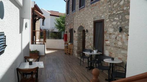 a patio with tables and chairs and a building at Pikan Ephesus in Selcuk