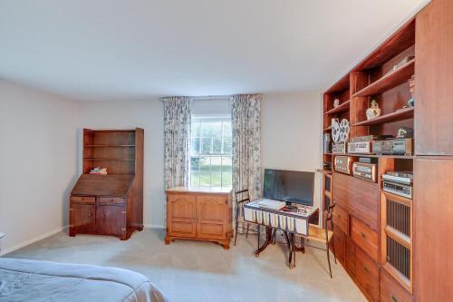 a bedroom with a bed and a desk and a television at Water-View Home in the Berkshires in Sheffield