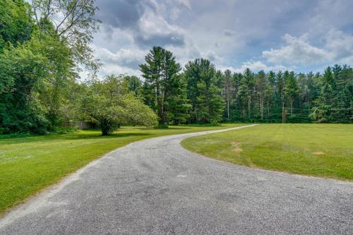 an empty road in a field with trees at Water-View Home in the Berkshires in Sheffield