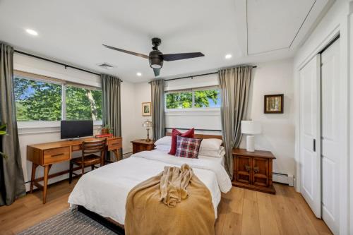 a bedroom with a bed and a desk with a computer at Modern Mid-Century Retreat in West Chester
