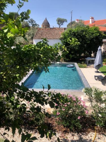 a swimming pool in the yard of a house at Casa dos Escritores - Casa de Férias com Piscina Privada in Marvão