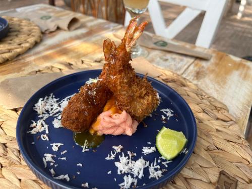 a blue plate with food on a table at Rosario EcoHotel in Isla Grande