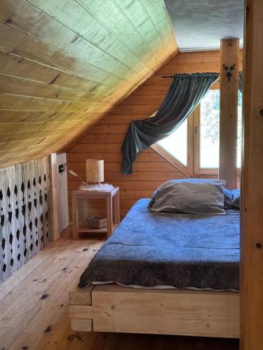 a bedroom with a bed in a wooden cabin at Alice Chalet Bled - Adults only in Bled