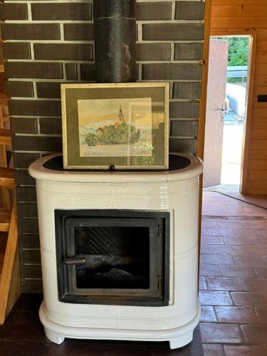 a fireplace with a picture on top of it at Alice Chalet Bled - Adults only in Bled