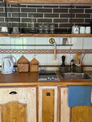 a kitchen with wooden cabinets and a sink at Alice Chalet Bled - Adults only in Bled
