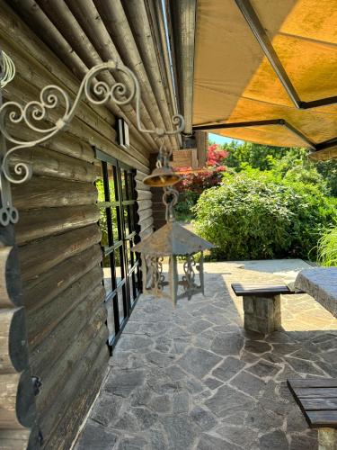 a patio with a bench and a wooden wall at Alice Chalet Bled - Adults only in Bled