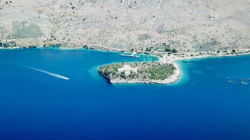 an island in the middle of a body of water at Diora'S Hotel and Apartments in Vlorë