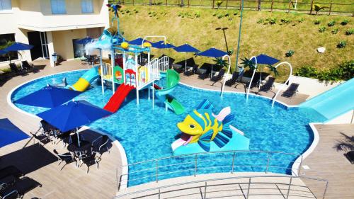 an image of a pool with a water slide at Vinhedo Plaza Hotel in Vinhedo