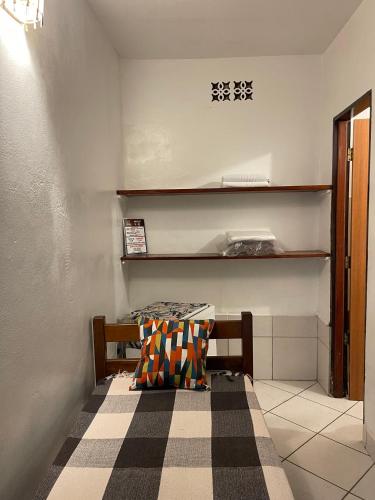 a small room with a table and a bench at Pousada do Cacau in Arraial d'Ajuda