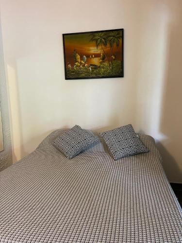 a bedroom with a bed with two pillows on it at Pousada do Cacau in Arraial d'Ajuda