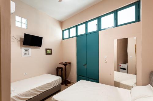 a room with two beds and a mirror at Στούντιο Στη Στοά Βαρβουτσή#9 in Kalamata