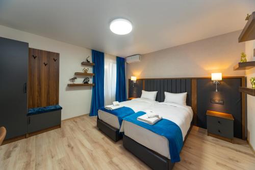 a bedroom with a large bed with blue sheets at Gori Apartments in Gori