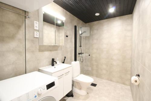 a bathroom with a toilet and a sink and a shower at Forenom Serviced Apartments Tampere Hervanta in Tampere
