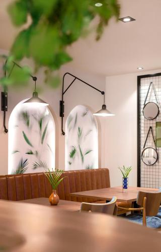 a dining room with two white chandeliers and tables at Apt with best rated breakfast ZAP B&B in Split