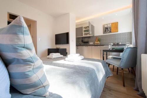 a hotel room with a bed and a desk at Cozy Studio by Ivanka Design in Novi Sad
