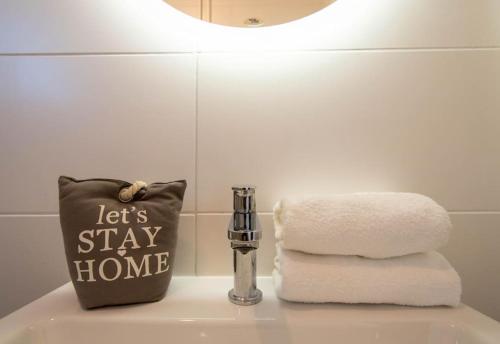 a bathroom sink with a pillow and towels on it at Cozy Studio by Ivanka Design in Novi Sad
