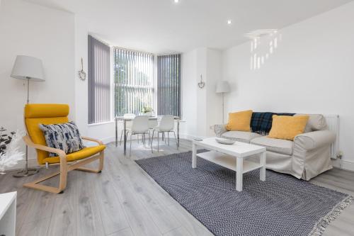 a living room with a couch and a table at Lytham St Annes Luxury Apartment - No 2 Tides Reach in Lytham St Annes