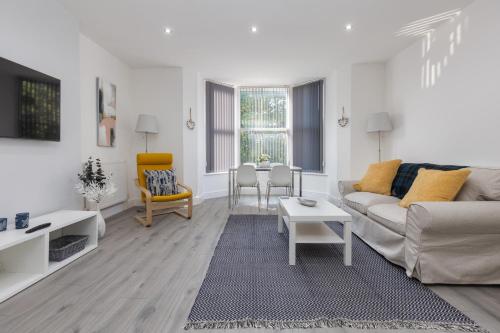 a living room with a couch and a table at Lytham St Annes Luxury Apartment - No 2 Tides Reach in Lytham St Annes