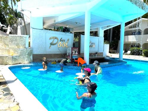 a group of people in the water at a swimming pool at Tropical Casa Laguna in Cabarete