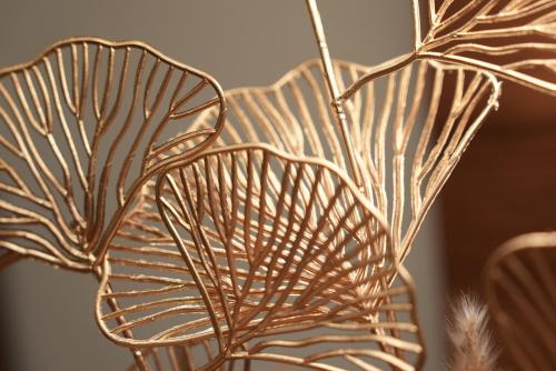 a close up of a metal vase with a plant at Hotel Attaché an der Messe in Frankfurt/Main