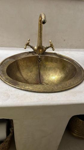 a bathroom sink with a faucet on a counter at Riad Rkiya with Courtyard in Tiznit