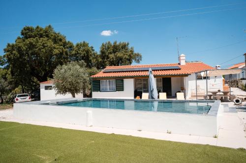 a swimming pool in front of a house at Casas de Marvão - Quinta da Bela Vista in Marvão
