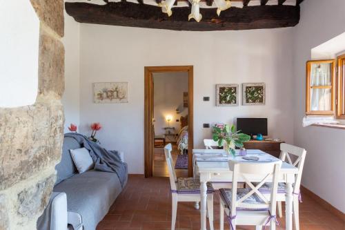a living room with a table and a couch at Casale Le Masse in Greve in Chianti