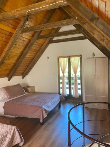 a bedroom with two beds and a wooden ceiling at Deni&Dino in Lohovo