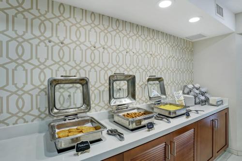 a buffet line with trays of food and mirrors at Staybridge Suites Columbia - Baltimore by IHG in Columbia