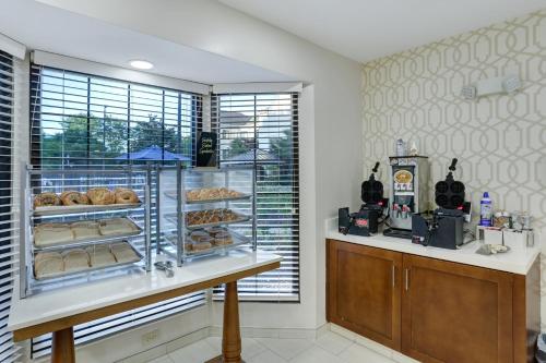 a bakery with a display case of donuts on a counter at Staybridge Suites Columbia - Baltimore by IHG in Columbia