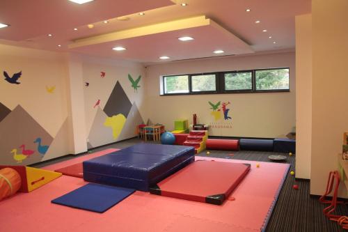 a childrens room with a play area with a play mat at Apartmán ve Vysokých Tatrách in Štrbské Pleso