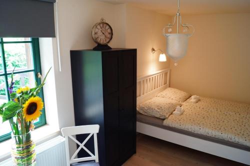 a small bedroom with a bed and a window at Penzion Zaječí důl in Mníšek