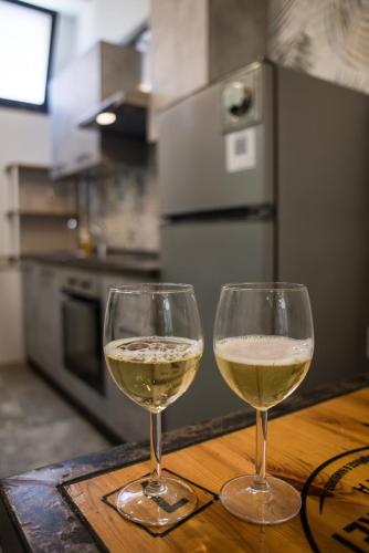 two glasses of white wine sitting on a table at Sweet Loft Ostia in Lido di Ostia