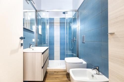a bathroom with a toilet and a sink and a shower at Relis rooms in Quartu SantʼElena