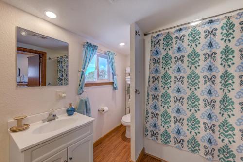 a bathroom with a sink and a toilet at Moonbeam Condo - Beautiful 2 Bedroom Stay by Beach in Pepin