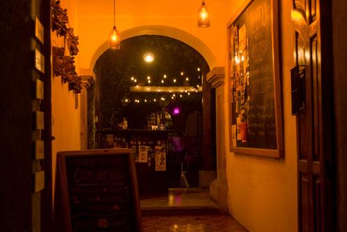 an entrance to a restaurant with a sign in the doorway at Tzunun Hostel in Antigua Guatemala