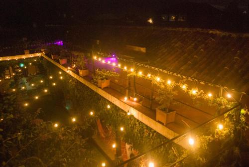 an overhead view of a pool at night with lights at Tzunun Hostel in Antigua Guatemala