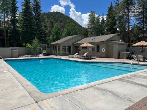 a swimming pool in front of a house at 2BR Keystone Condo Near Slopes in Keystone