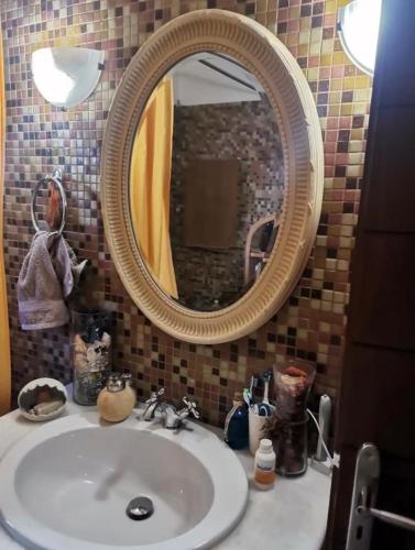 a bathroom with a sink and a mirror at Αναστασία in Diakopto