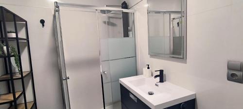 a white bathroom with a sink and a shower at El Mirador De San Juan in Zamora