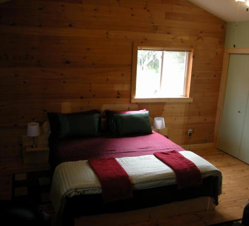 a bedroom with a bed in a log cabin at Waterview B&B in Pictou