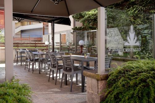 a row of tables and chairs at a restaurant at Hotel Cristallo in Bormio