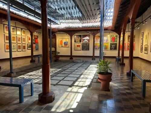 a building with benches and paintings on the walls at Hotel Tranquilo in Las Peñitas